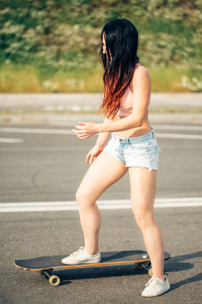 Young hipster girl posing with longboard, skateboard, street photo, life style - Foto, Imagem