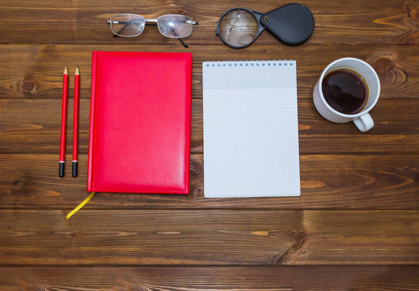 note book and pencil with cup coffee on wooden table - Foto, Imagem