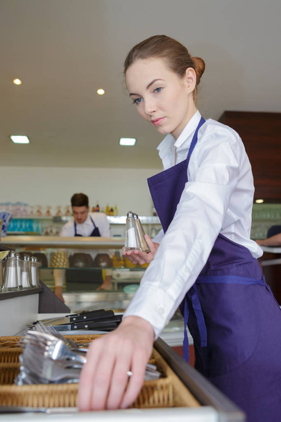 female waitress sorting cutlery - Фото, изображение