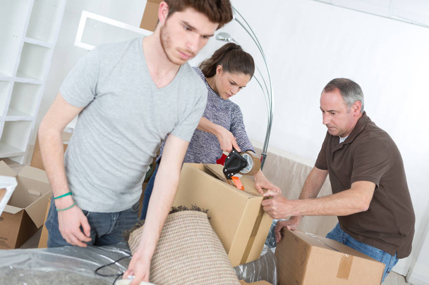 family packing cardboard boxes - Foto, imagen