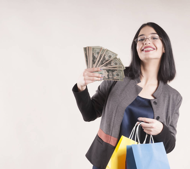 beautiful girl braces with money and shopping bags - Zdjęcie, obraz