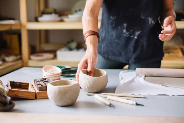 pottery craftsmanship potter craftsman hands working red clay - 写真・画像