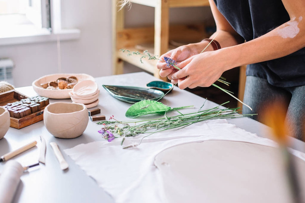 artist woman hands working red clay to create handcraft art - Foto, Bild