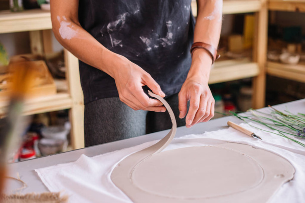 artist woman hands working red clay to create handcraft art - Fotó, kép