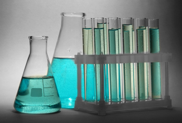 test-tubes with blue liquid on grey background - Фото, зображення