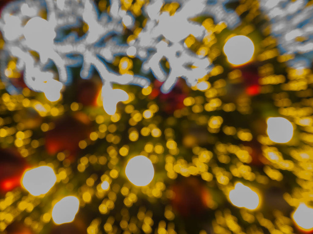 Θάμπωμα φόντου εικόνας της ερυθρελάτης, τεχνητές πευκοβελόνες χριστουγεννιάτικο δέντρο, bokeh του Led διακοσμητικά φως defocused και υφή, για παραμονή των Χριστουγέννων, το νέο έτος κόμμα αργία και γιορτή φόντο - Φωτογραφία, εικόνα