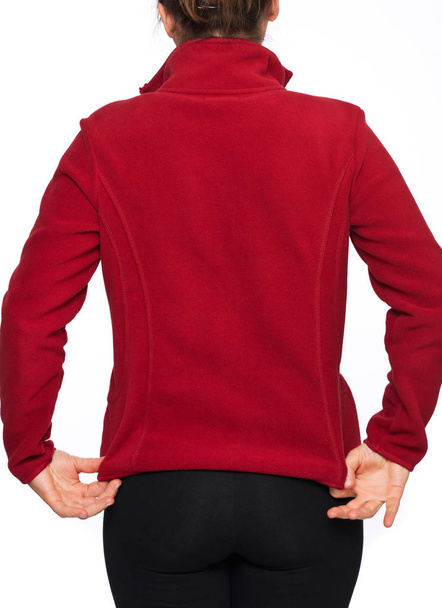 Young woman wearing red polyester jacket sweater separated on white background - Valokuva, kuva