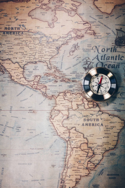 Old compass on vintage map. Adventure stories background. Retro  - Photo, Image