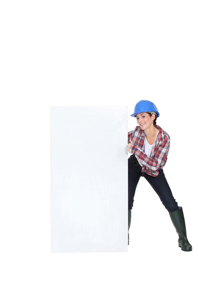Woman laborer showing white board for message - Фото, изображение