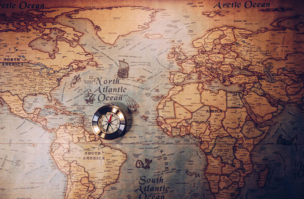 Old vintage retro golden compass on ancient map. Selective focus - Photo, Image