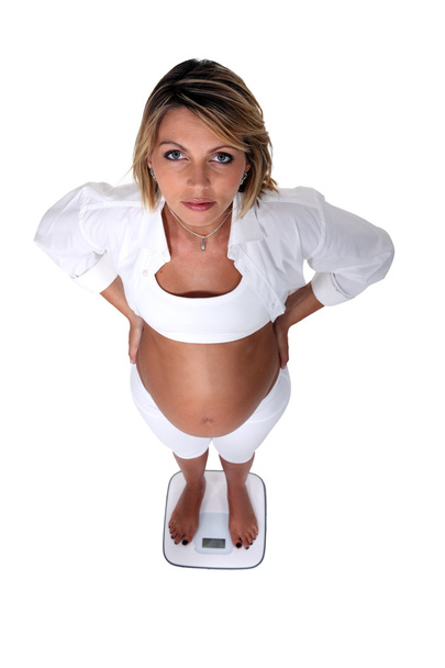 Pregnant women weighing herself - Фото, изображение