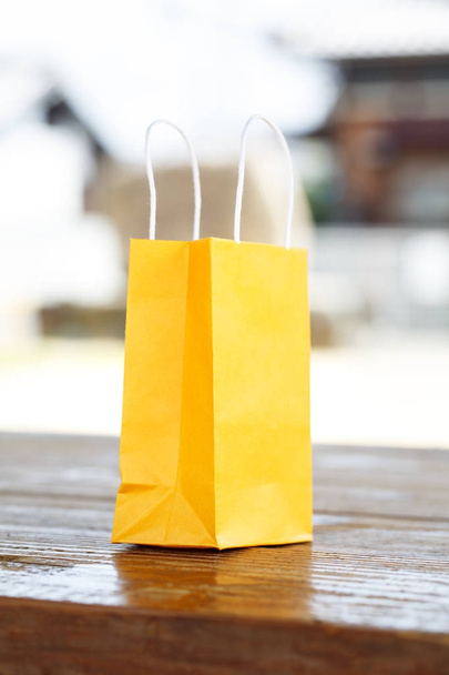 a yellow bag on light blurred background - Foto, imagen