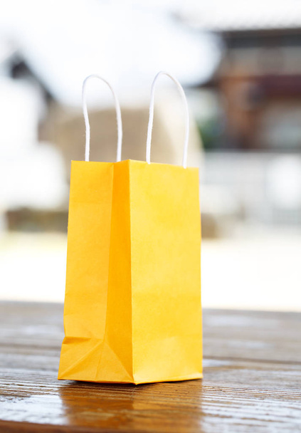 a yellow bag on light blurred background - Foto, imagen
