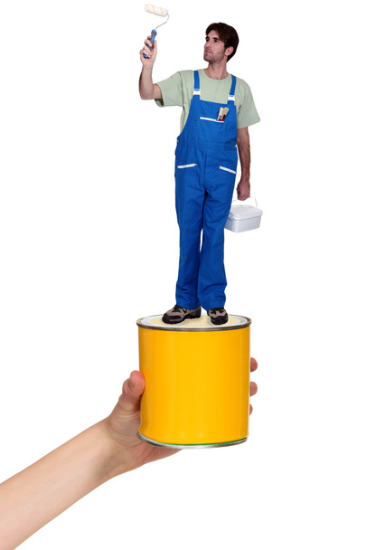 Decorator standing on a pot of paint - Foto, imagen