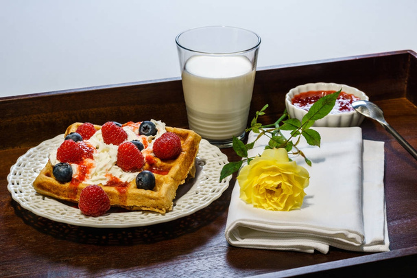 Fresh belgian waffle with berries with milk breakfast on a tray. - Foto, Imagen