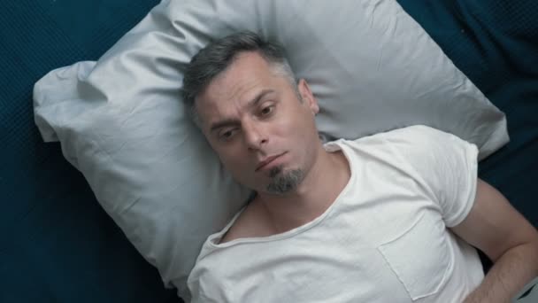 A man goes to sleep after a hard day. - Video, Çekim