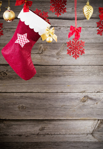 Christmas stocking hanging against wooden background - Фото, изображение
