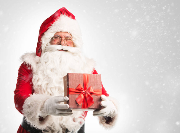 Santa Claus with gift  isolated on white background  - Фото, зображення