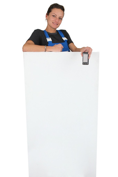 Female plumber stood with marketing panel - Photo, Image