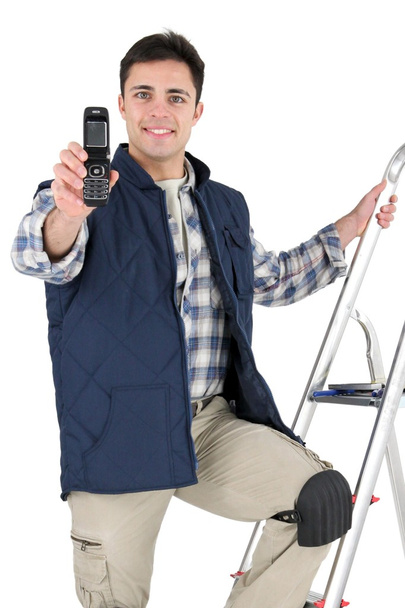 Tiler holding a cell phone - Zdjęcie, obraz