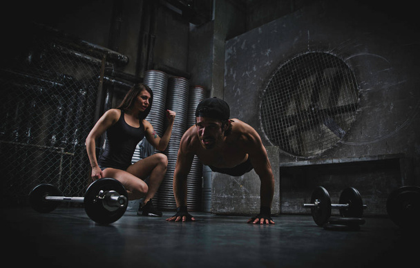 Young people making functional training in the grungy gym - 写真・画像