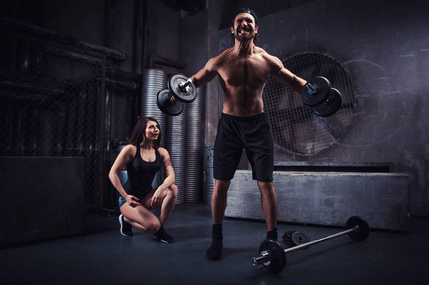 Young people making functional training in the grungy gym - 写真・画像