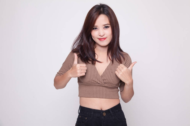 Young Asian woman show two thumbs up. - Zdjęcie, obraz