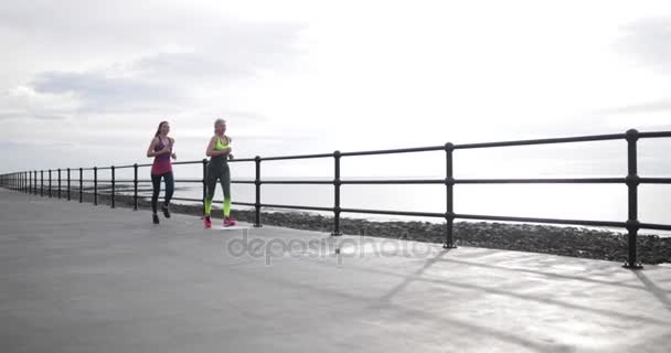 senior woman running with younger woman - Filmagem, Vídeo