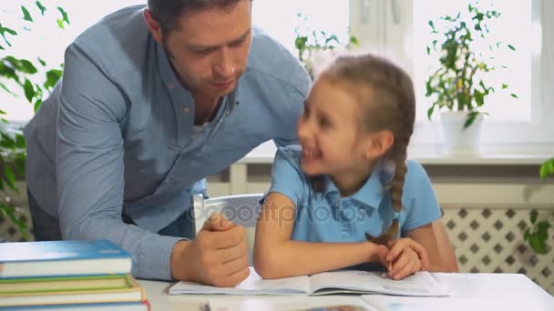 Father helping daughter with homework at home. - Footage, Video