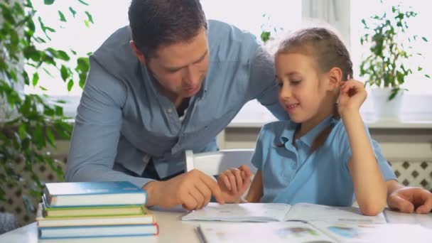 Father helping daughter with homework at home. - Footage, Video