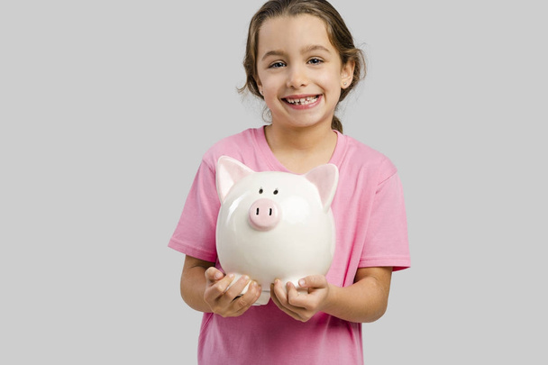 girl holding piggy bank - 写真・画像