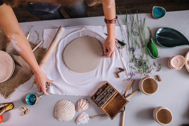 artist woman hands working red clay to create handcraft art - 写真・画像