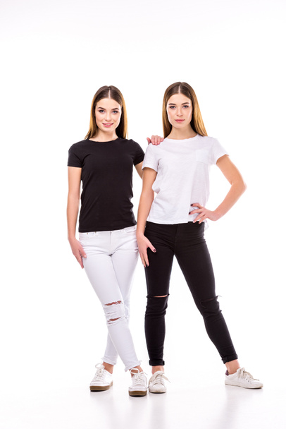 twins in black and white stylish clothing posing isolated on white - Photo, Image
