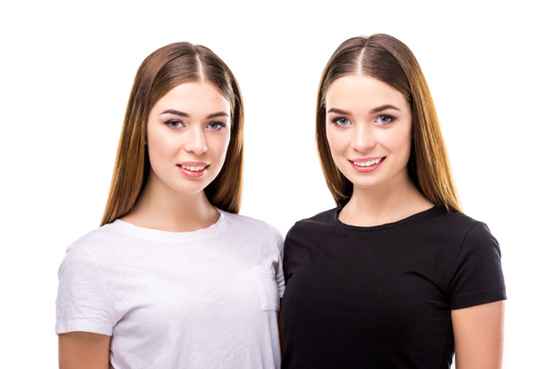 portrait of smiling twins in black and white stylish clothing isolated on white - Photo, image