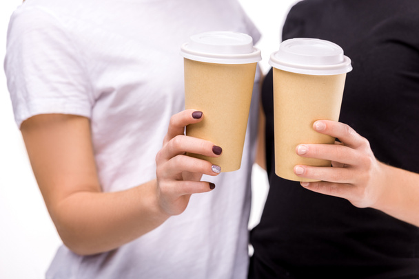 partial view of women holding coffee to go in hands isolated on white - Φωτογραφία, εικόνα