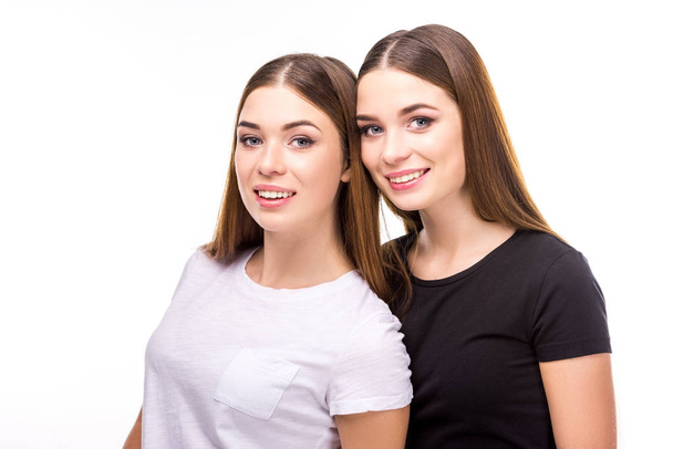 portrait of smiling twins in black and white stylish clothing isolated on white - Foto, immagini