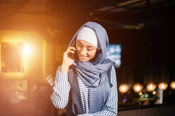 portrait of happy asian woman wearing hijab calling with mobile phone - Photo, Image