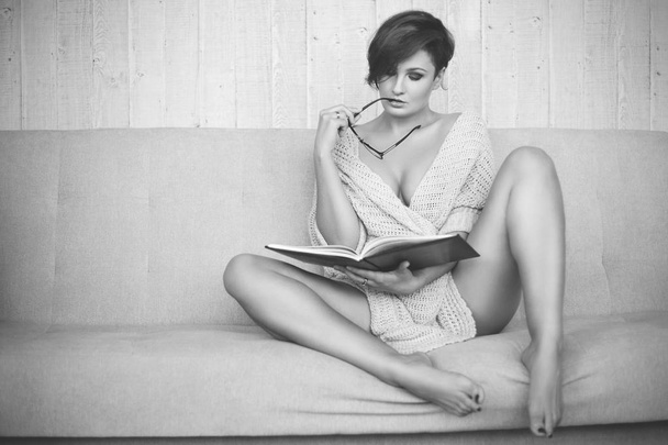 Sensual woman at home with a book - Foto, Imagen