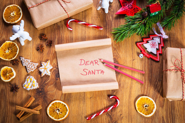 Christmas letter to Santa Claus on wooden table with christmas decorations - Zdjęcie, obraz