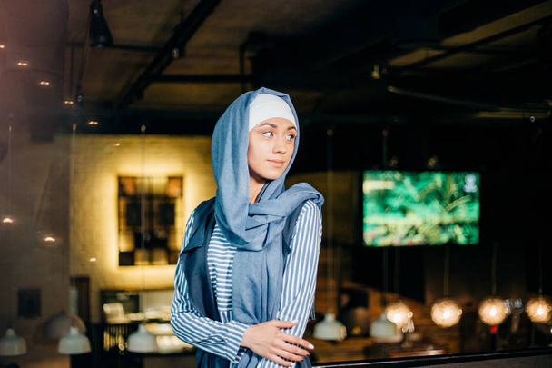 Portrait of a beautiful Muslim woman in cafe - Фото, изображение
