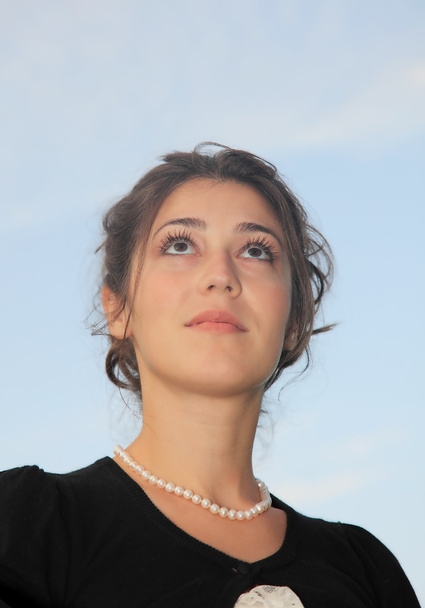 A beautiful girl looks at the sky - Valokuva, kuva