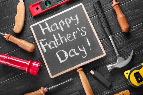 Chalk board with text Happy Father's Day and instruments on wooden background - Photo, Image