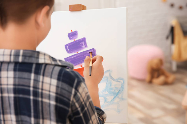 Little boy painting ship at home - Foto, imagen