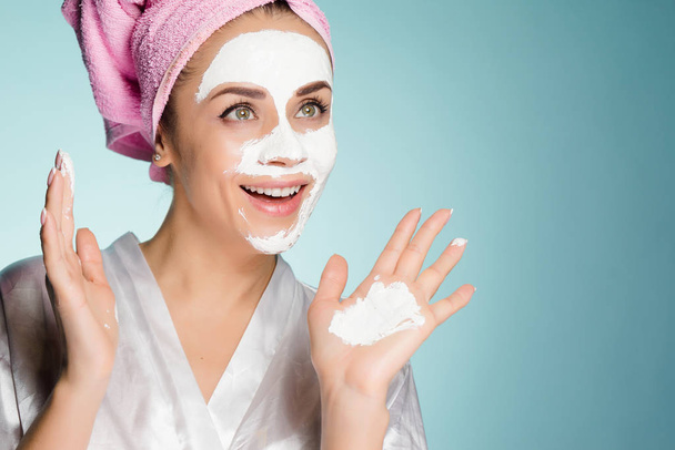 surprised happy girl wants to have a beautiful skin, puts a useful white mask on the face - Фото, зображення