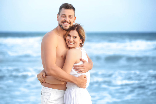 Happy couple on sea beach  - Фото, изображение