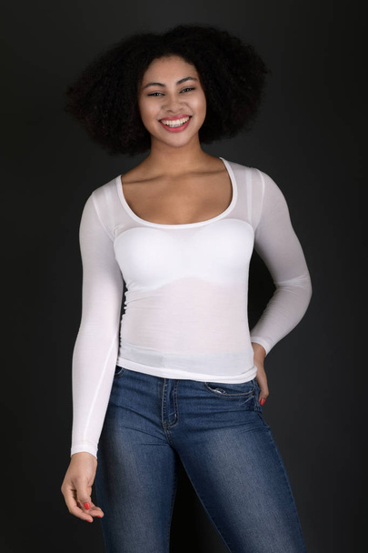 Young black woman with afro hairstyle smiling.  - Foto, Bild