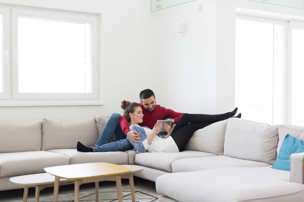 couple relaxing at  home with tablet computers - Foto, imagen