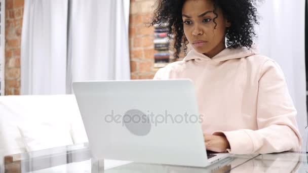 Afro-American Woman Sitting on Couch Upset by Loss, Working on Laptop - Кадры, видео