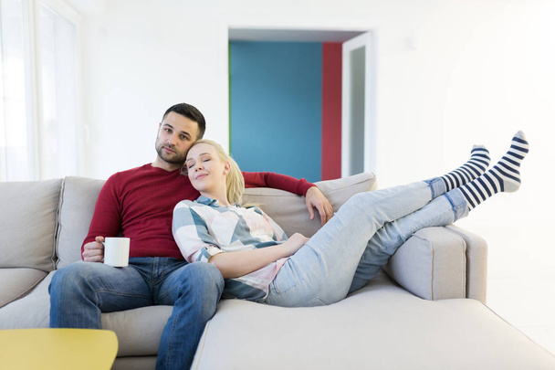 couple hugging and relaxing on sofa - Photo, Image