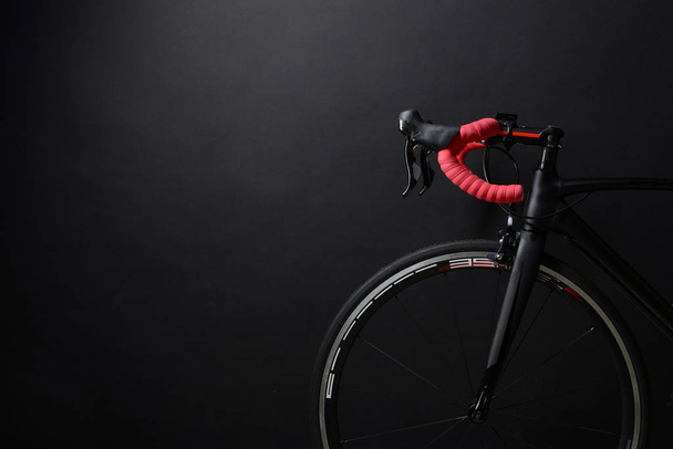 front and wheel of black race road bike - Фото, зображення